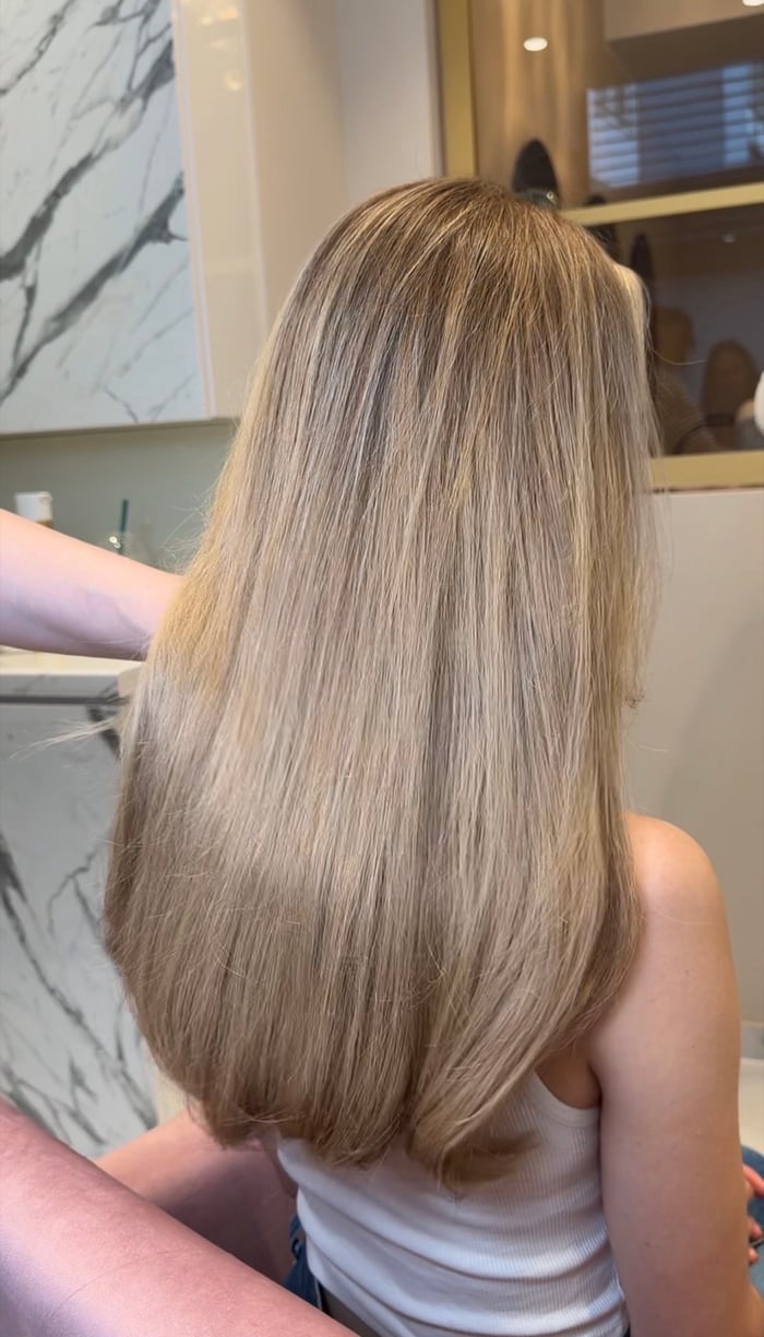 Langes dichtes dunkelblondes Haar nach der Haarverdichtung