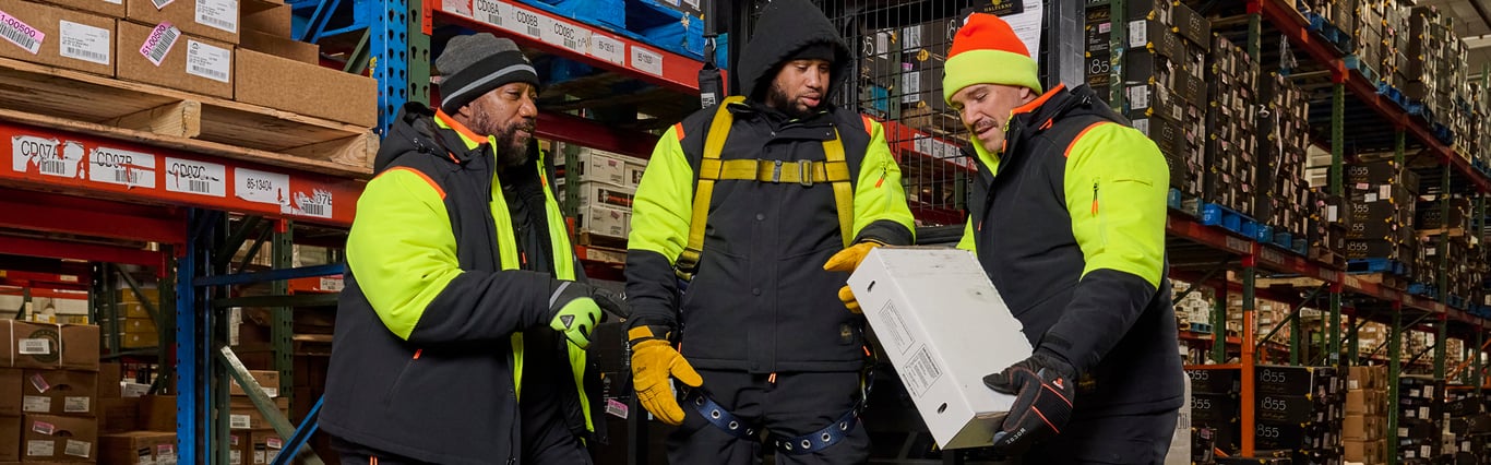 Group of people in a cold storage warehouse wearing RefrigiWear's FrostFlex System