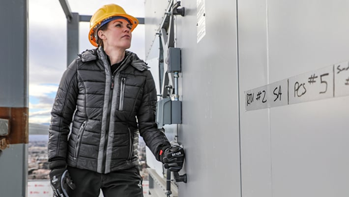 Woman in Refrigiwear working at a jobsite.