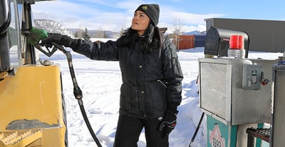 A woman outside working in Iron Tuff work wear.