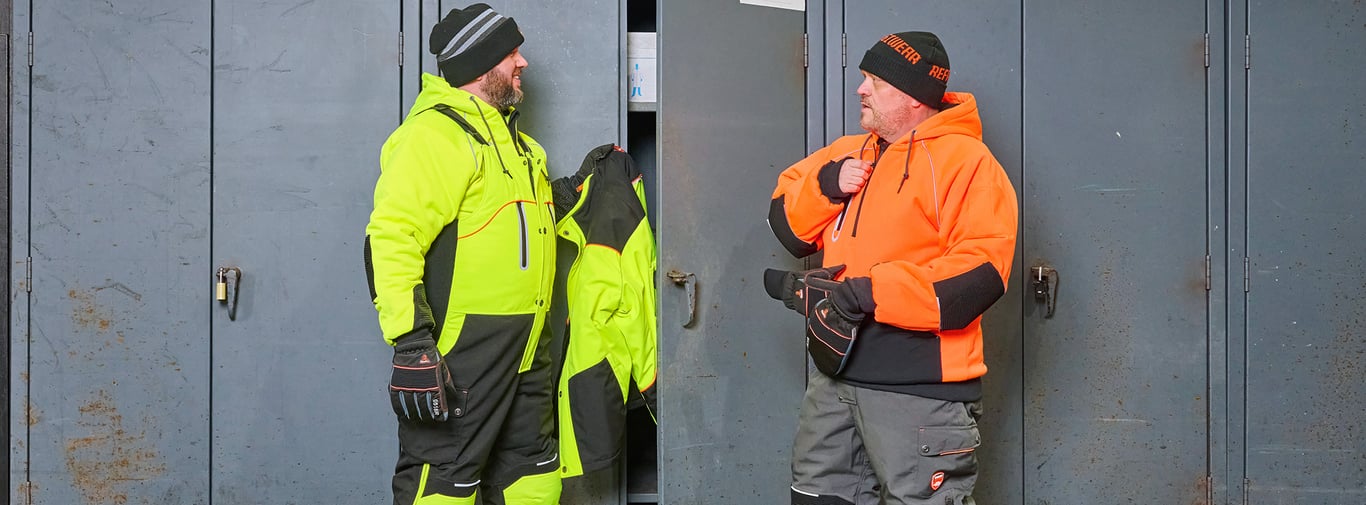 Two men wearing RefrigiWear HiVis PPE talking