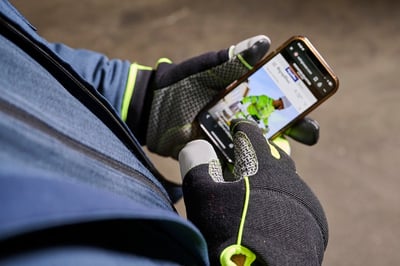 Person uses touchscreen gloves in a cold storage freezer