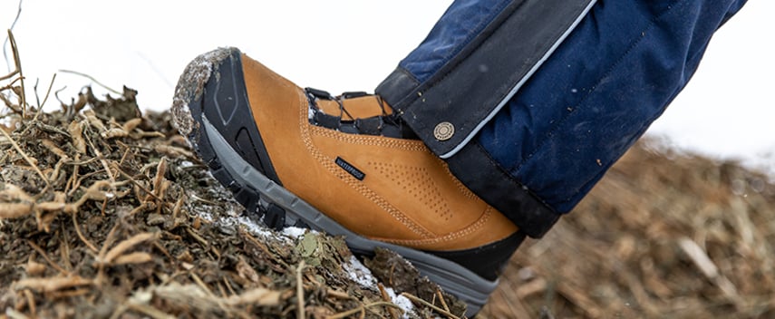 Person walking on a ranch in the winter wears insulated waterproof work boots.