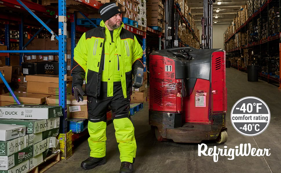 Man standing in a cold storage warehouse wearing HiVis Polarforce Bib overalls