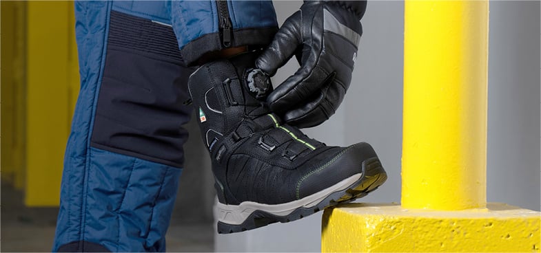 Person tightening BOA system on Extreme Freezer Boots
