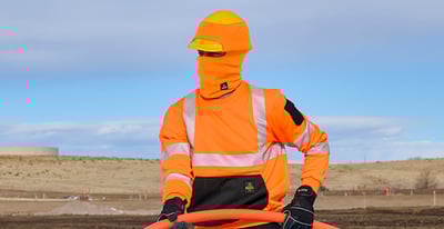 Man dressed in hivis bib overalls working at the roadside
