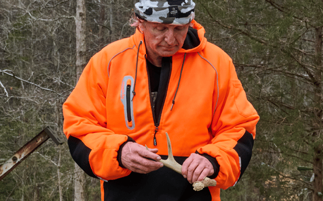 Man wearing HiVis PolarForce Sweatshirt holding an deer shed