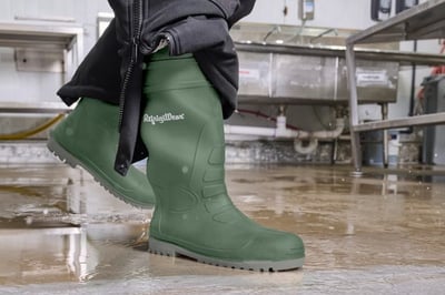 Person wearing safety toe processing boots in wet conditions