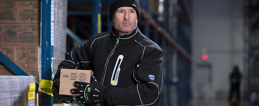 Man working in a subzero freezer wears insulated jacket and impact-resistant insulated work gloves.