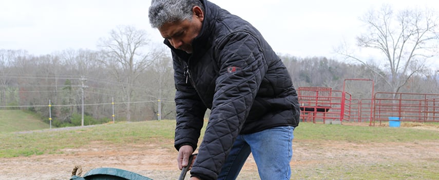 Man working outside in the fall wears an insulated puffer jacket.