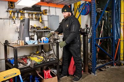 Man wearing insulated coveralls at work