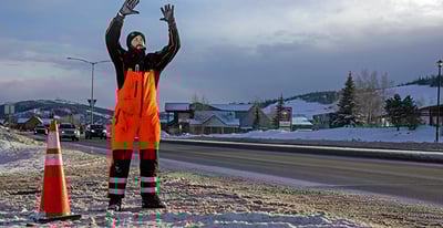 Man dressed in hivis bib overalls working at the roadside