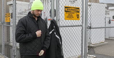 A man preparing for work in refrigiwear workwear.