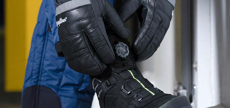 Close-up of a person tightening the BOA system on their RefirigWear work boots