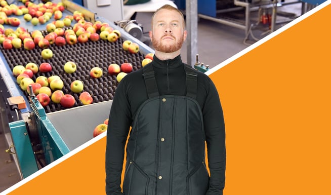 Man wears insulated workwear in a produce packing plant.