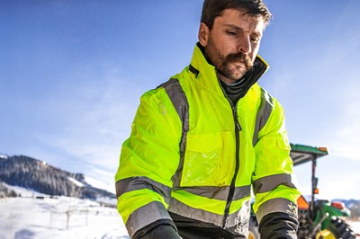 Man wearing waterproof workwear in snow