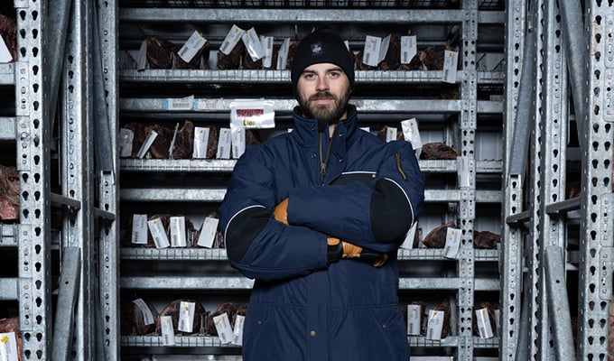 Protein_processing_work_ wear_insulated_gear_RefrigiWear_Man_working_with_meat