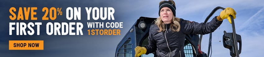 Female construction worker wearing properly fitting insulated PPE jacket and gloves, highlighting OSHA-compliant women's workwear for cold weather job sites