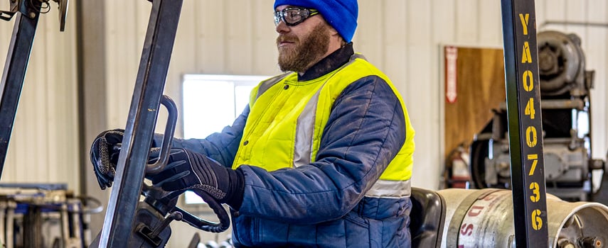 Man driving forklift in Hivis workwear