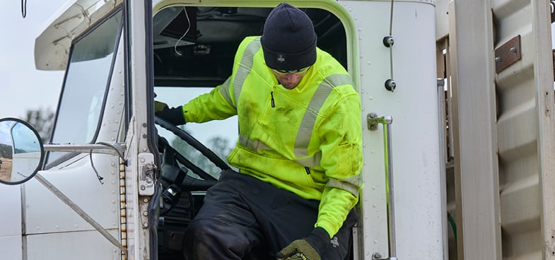 Delivery driver exiting semi truck