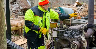Man in PolarFoce PPE working on an engine