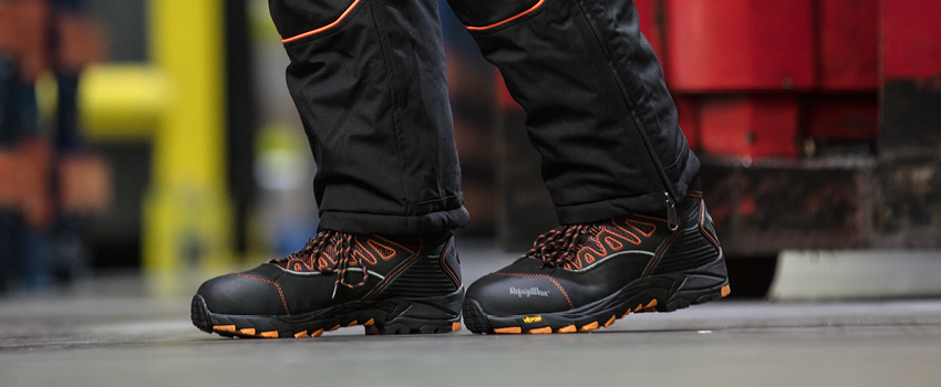 Person working in a freezer warehouse walks in thermal work boots with soles specially formulated to withstand  prolonged contact with frozen concrete floors.