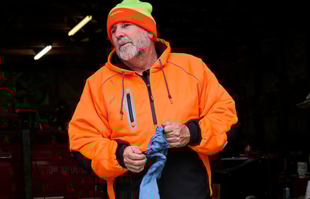 Man wearing HiVis PolarForce Sweatshirt holding a grey cloth