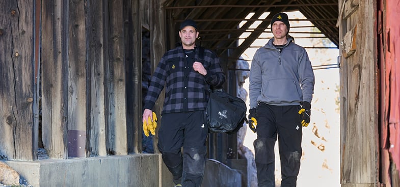 Two men walking in the cold, wearing RefrigiWear gear