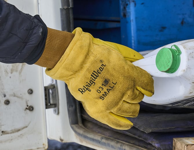Hand wearing the RefrigiWear 0315 glove grabbing a container