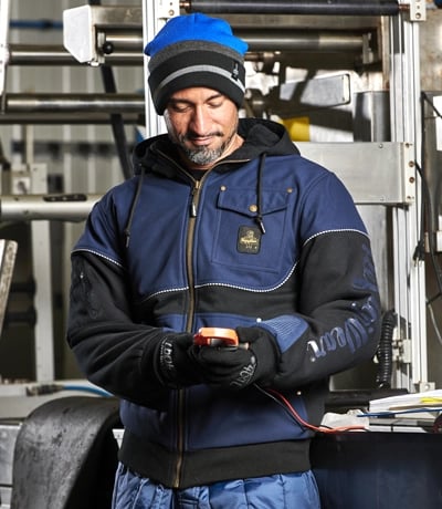 man wearing the PolarForce jacket and gloves working on a construction site