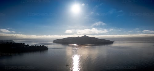 Aerial Picture at Sunrise--facing the sun--of Angel Island with Sailboat in Sausalito, California.