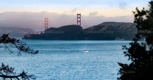 Picture of Golden Gate Bridge at Sunset with Sailboats in the foreground from Belvedere Island, California. 