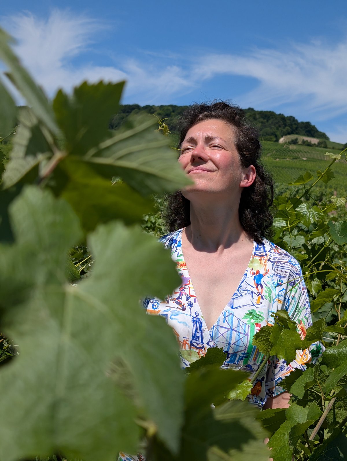Alexandra zwischen Weinreben an einem sonnigen Tag