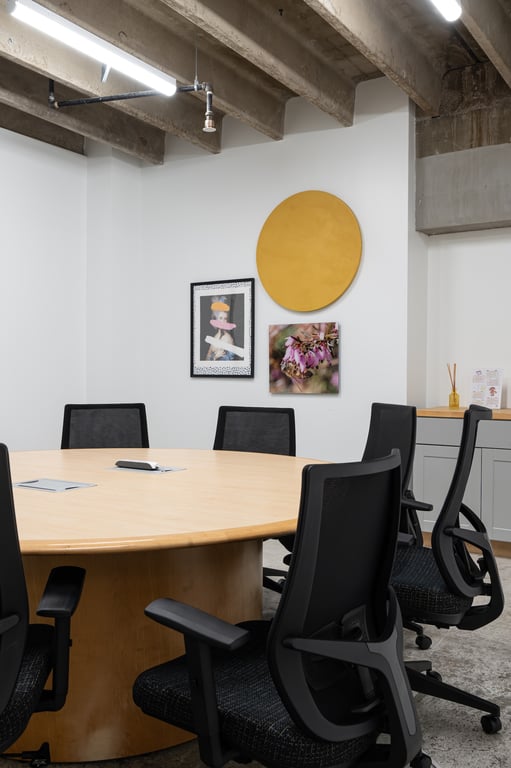 An interior shot of 10 Person Large Conference Room with Round Table