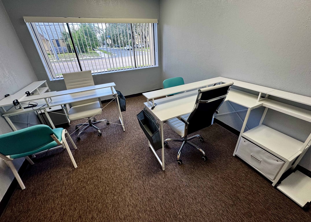 An interior shot of Private Office #103 (2 Desks – Window Office) – No Glass. Just Walls. Real Privacy.