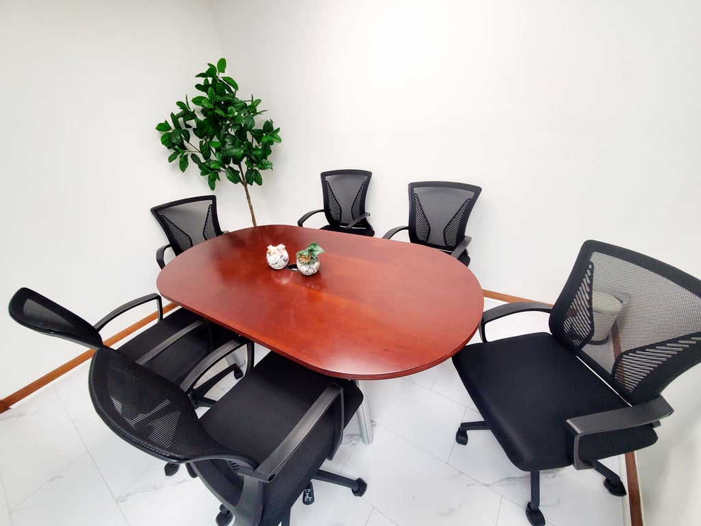 An interior shot of Meeting Room #102 – Round Table for 6 | Private & Collaborative Space