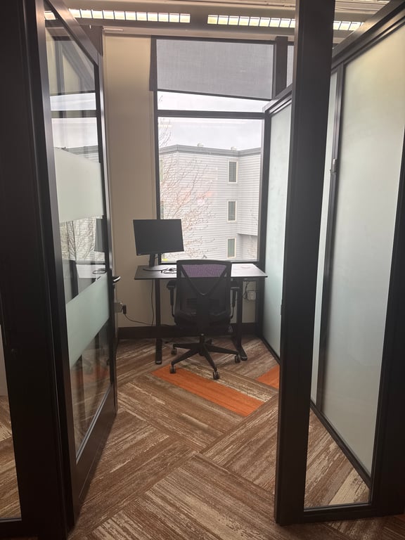 An interior shot of Private Window Office | Sit-Stand Desk + Cold Brew & Kombucha on Tap