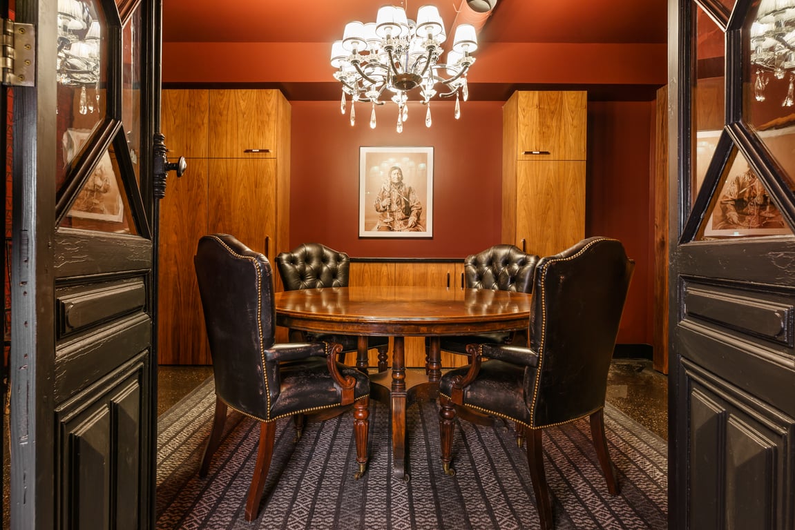 An interior shot of Conference Room for 4-6 w/ TV and fridge