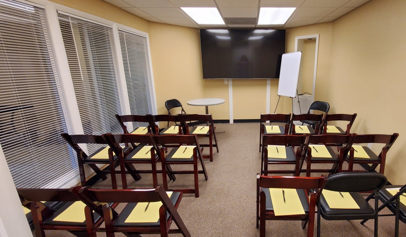 An interior shot of Private Conference & Seminar Room for 15 – Room #204 | Executive Space for High-Impact Meetings