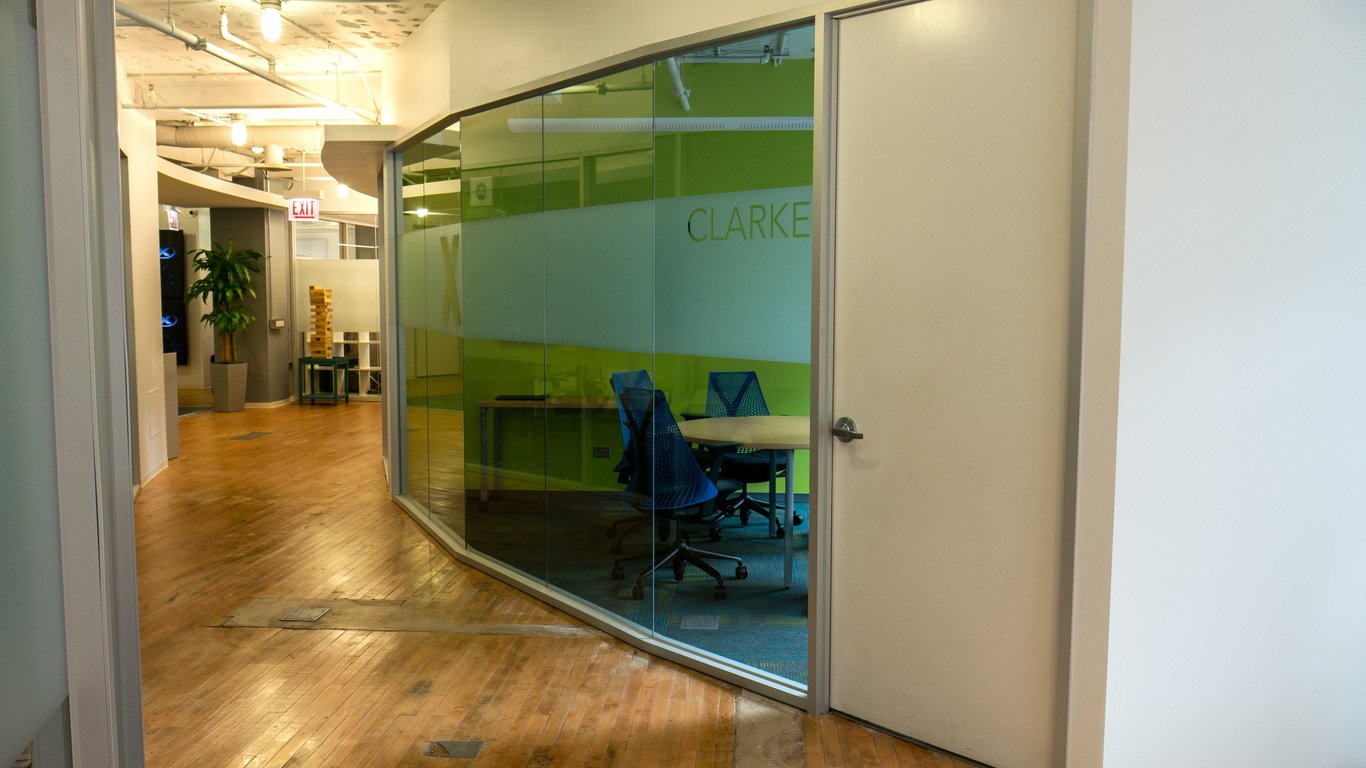 An interior shot of Virtual Enabled Meeting Rooms with City Views | Ideal for In-Person & Virtual Off-sites | Bright & Modern in a Tech Focused Shared Workspace! Clarke Boardroom