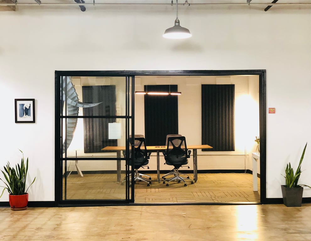 An interior shot of Avocado Room: 8-Person Meeting & Conference Room in Industrial Coworking Space