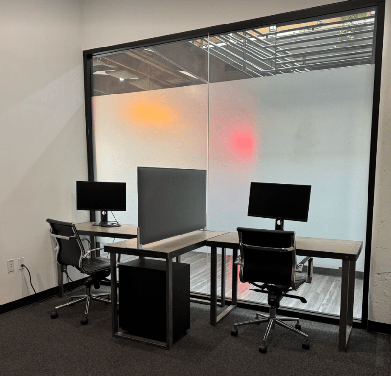 An interior shot of Office 102 - 2 Person 1st Floor Workspace with Whiteboard Wall