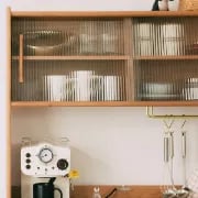 Prosy Kitchen Cabinet – Natural Wood with Glass Doors and Gold Handles