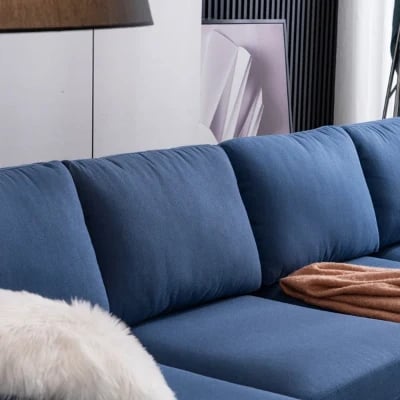 صورة مودين كنبة ركنية على شكل حرف الـ – بقاعدة من الخشب الطبيعي