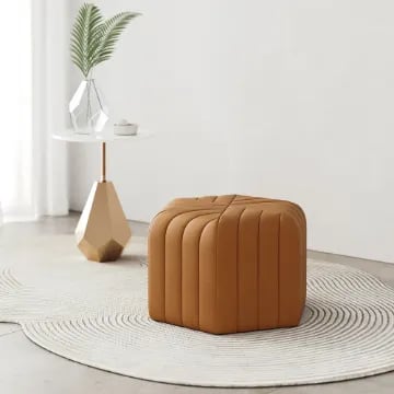 Maven – Upholstered ottoman with a simple and elegant design and a natural wood frame.