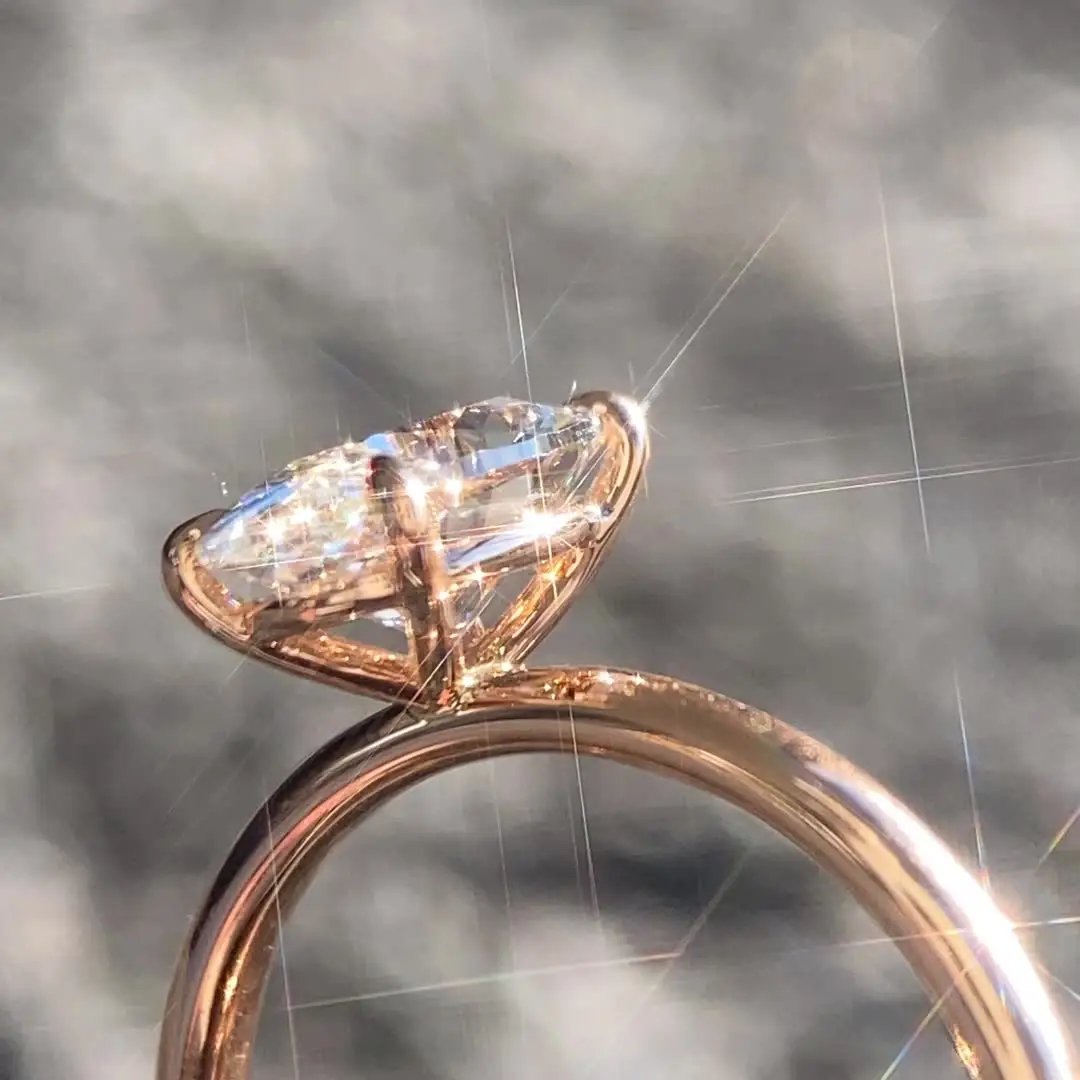 a gold metal ring with diamond as a center stone. 