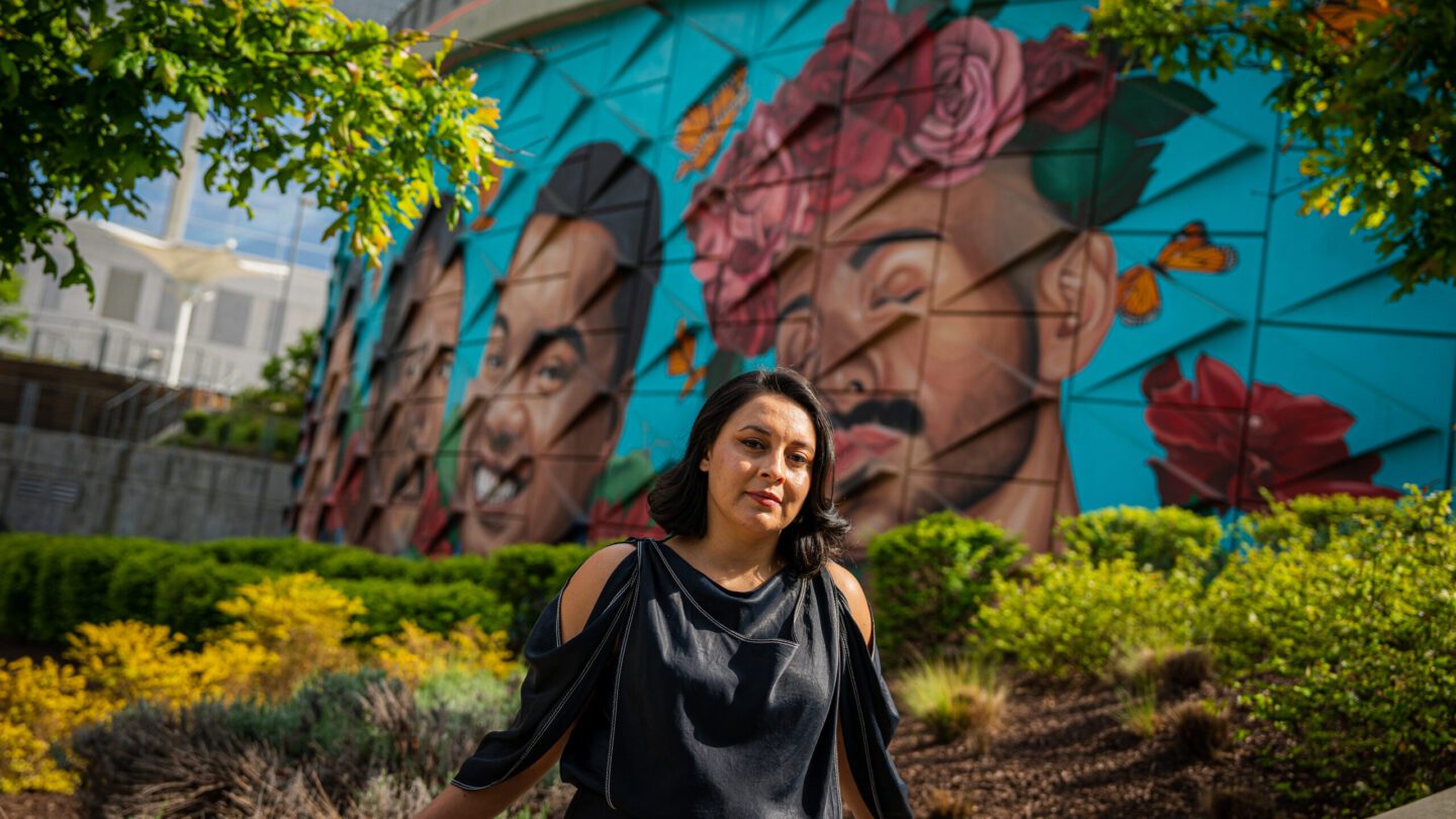 Woman in front of mural