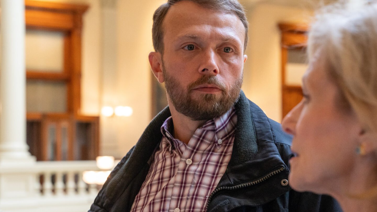 Man with serious expression talking with woman