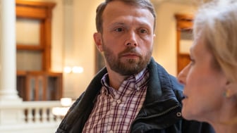 Man with serious expression talking with woman
