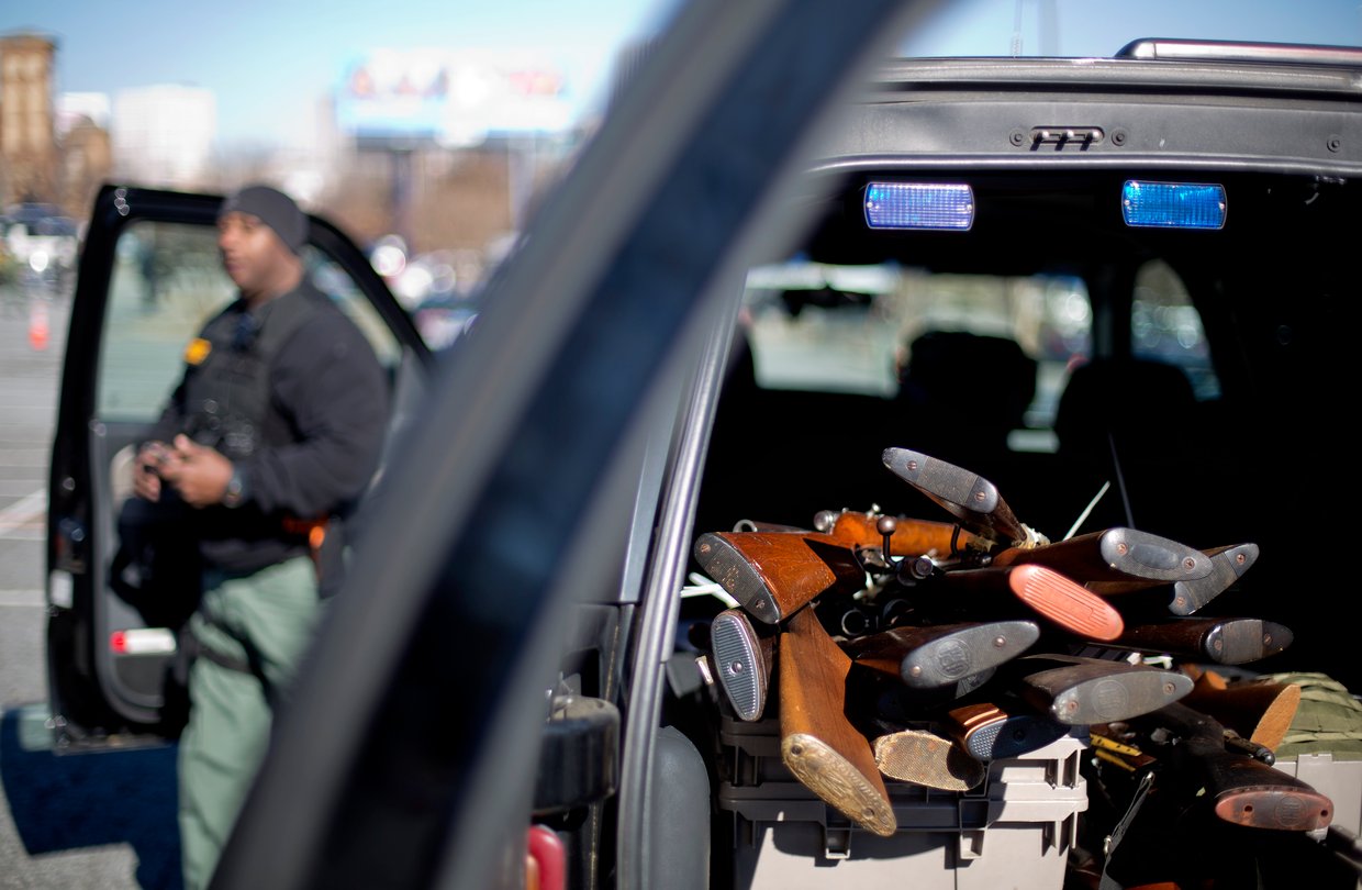 Rifles stacked in the back of a car
